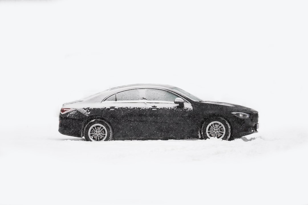 black porsche 911 on snow covered ground