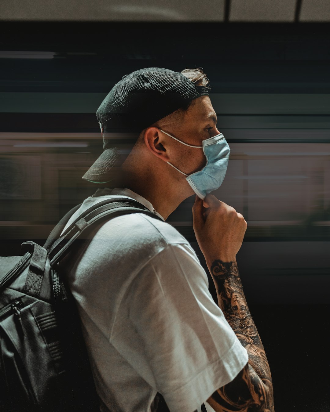 man in white shirt and black leather backpack