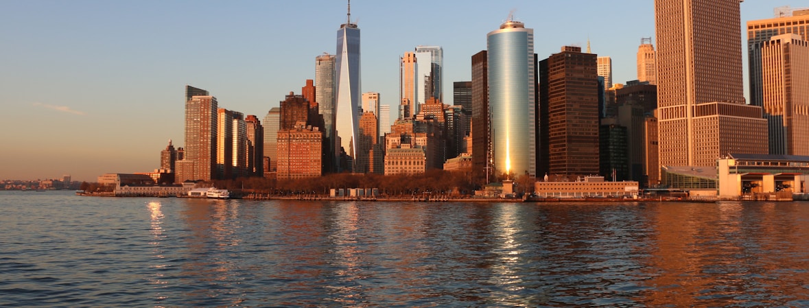 city skyline across body of water during daytime