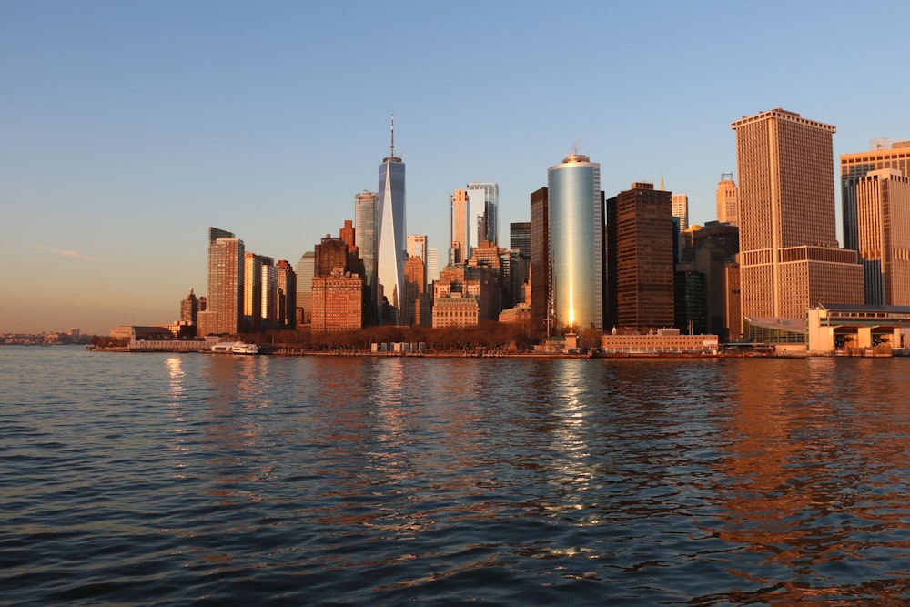 city skyline across body of water during daytime