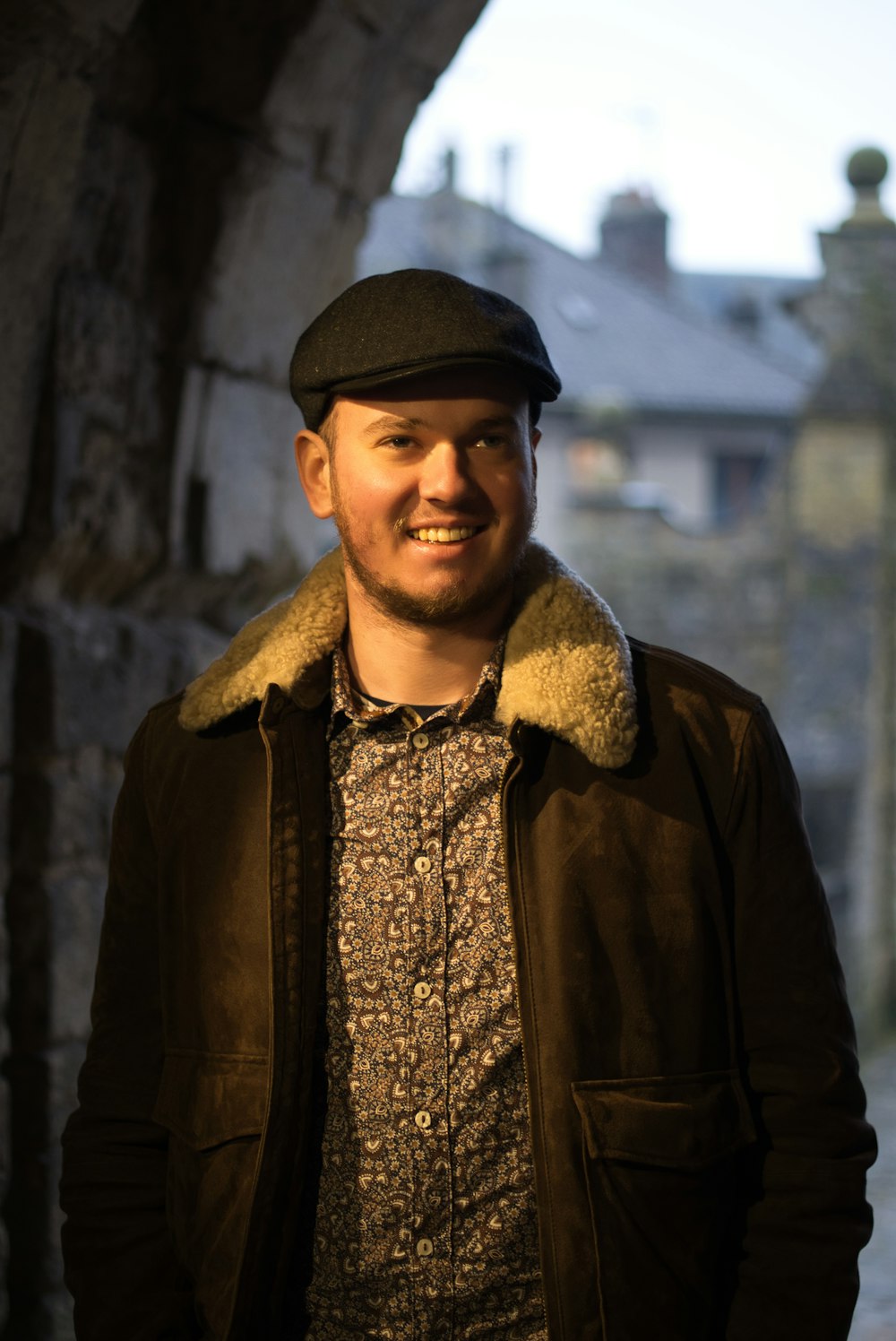 man in black leather jacket and black cap