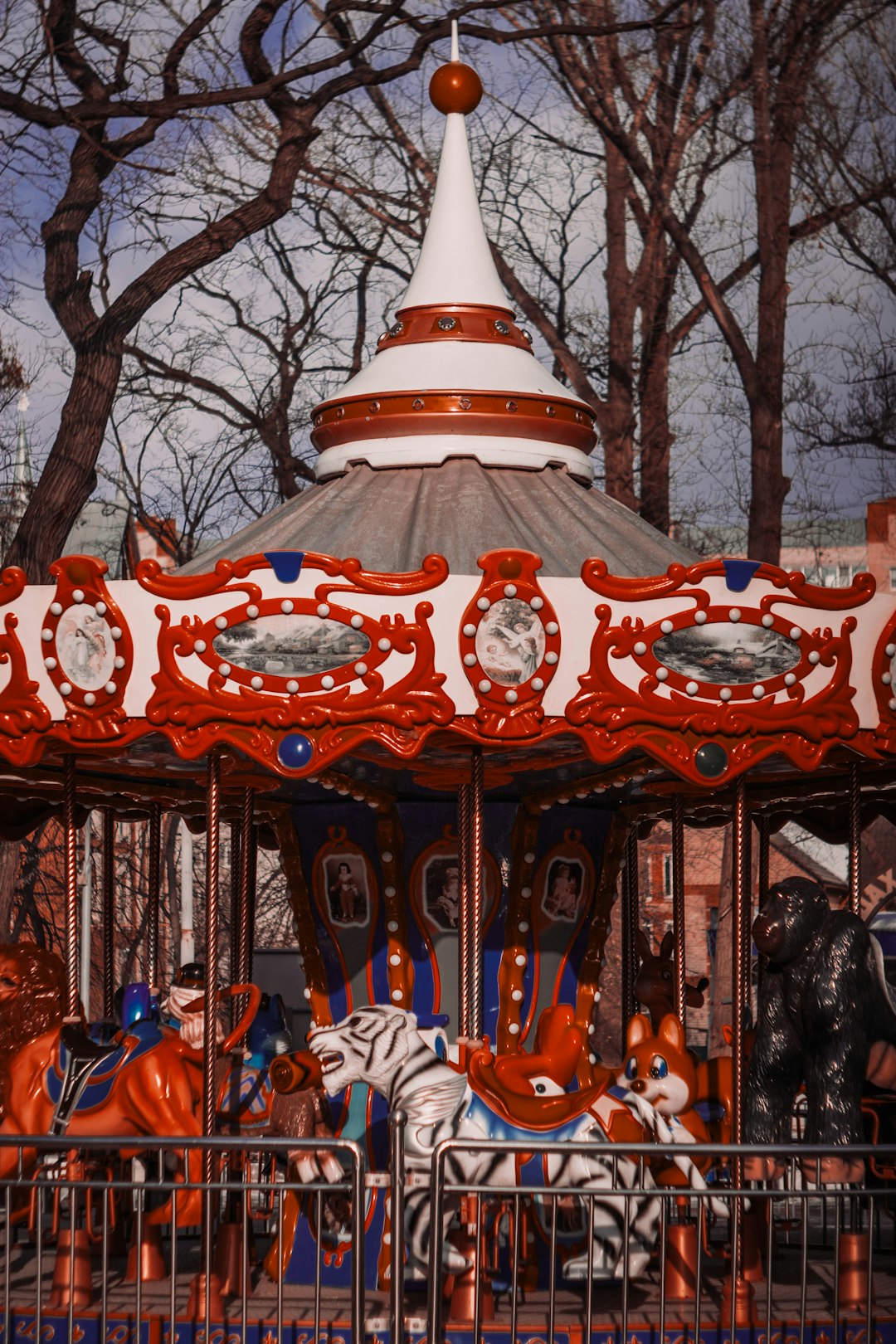 people riding on carousel during daytime