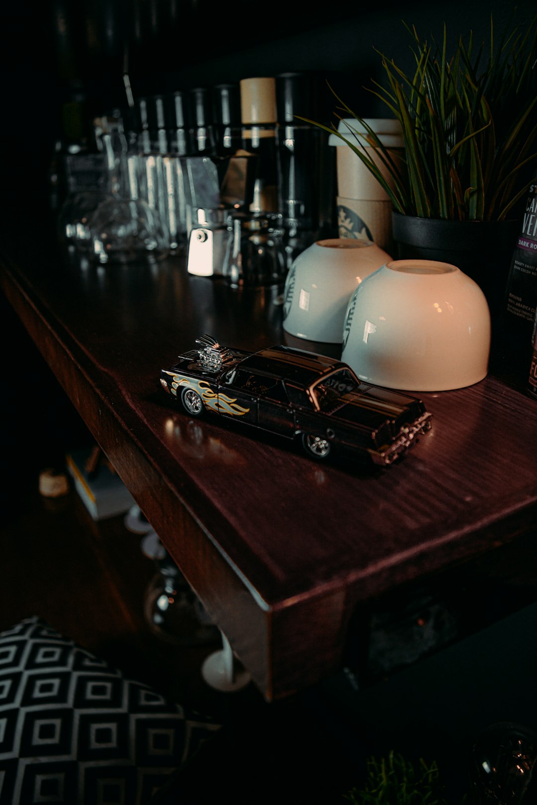 black and white car scale model on brown wooden table