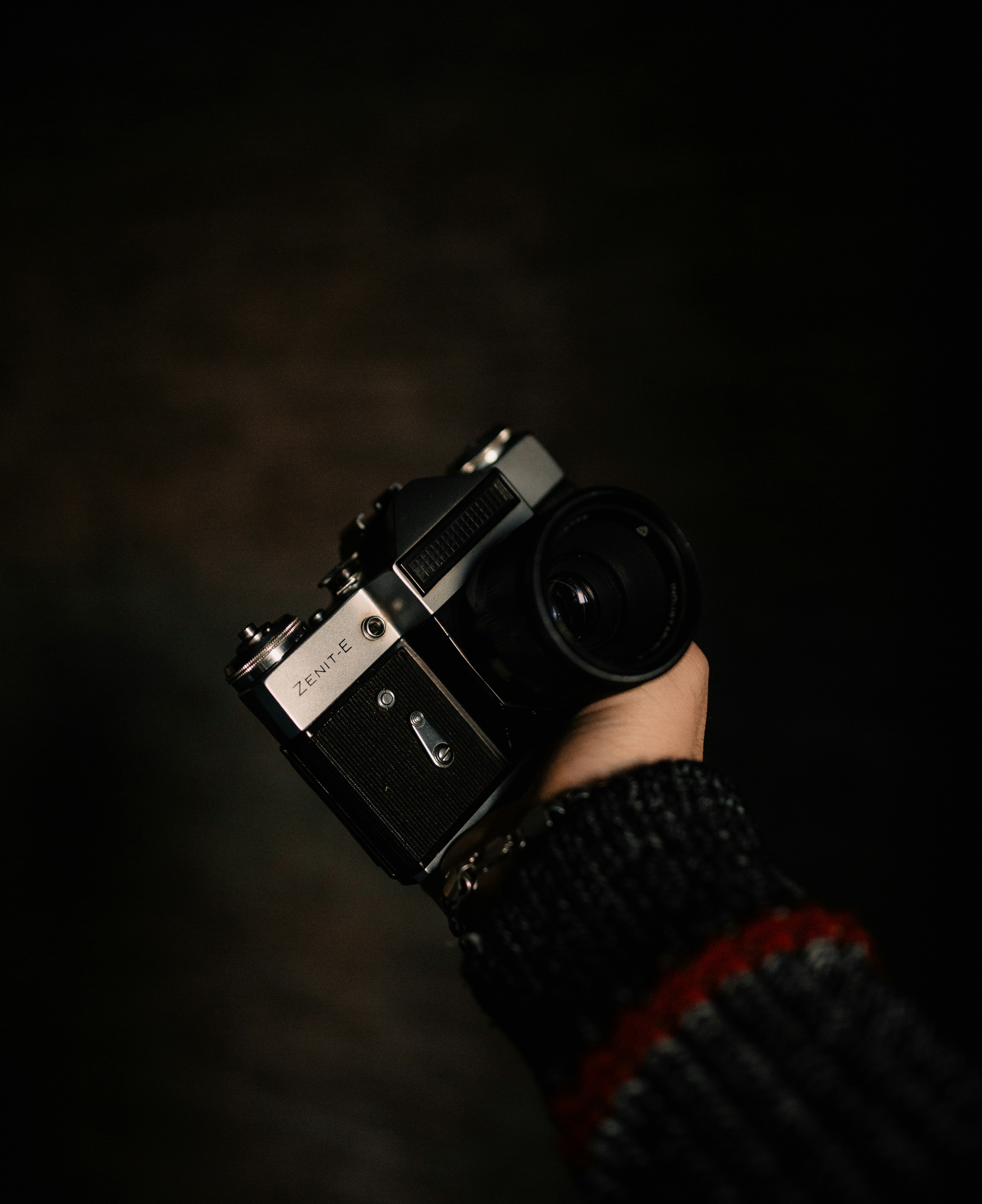 person holding black and silver dslr camera