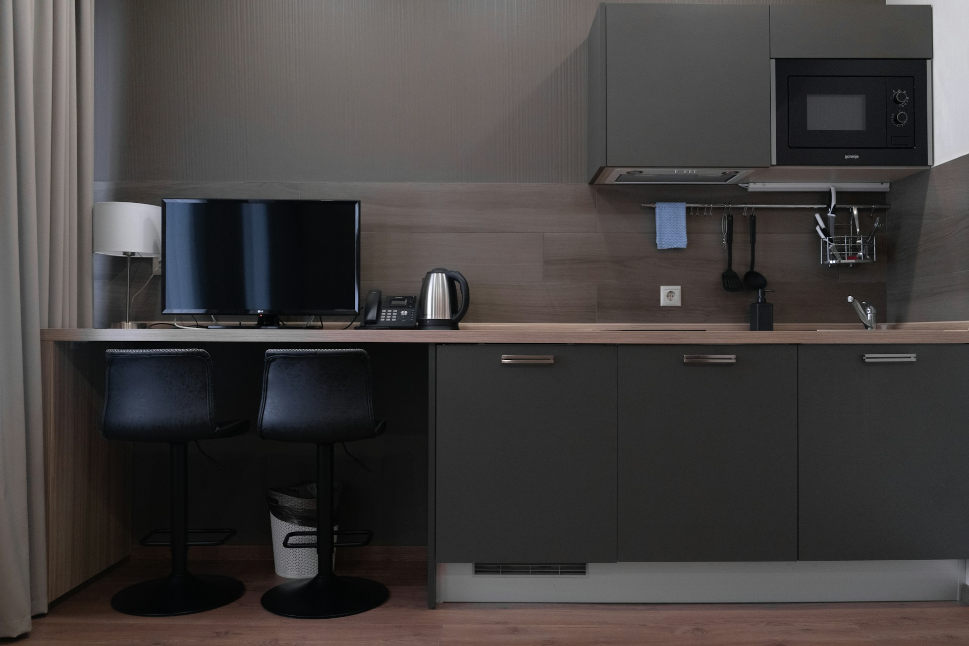 black flat screen computer monitor on brown wooden desk