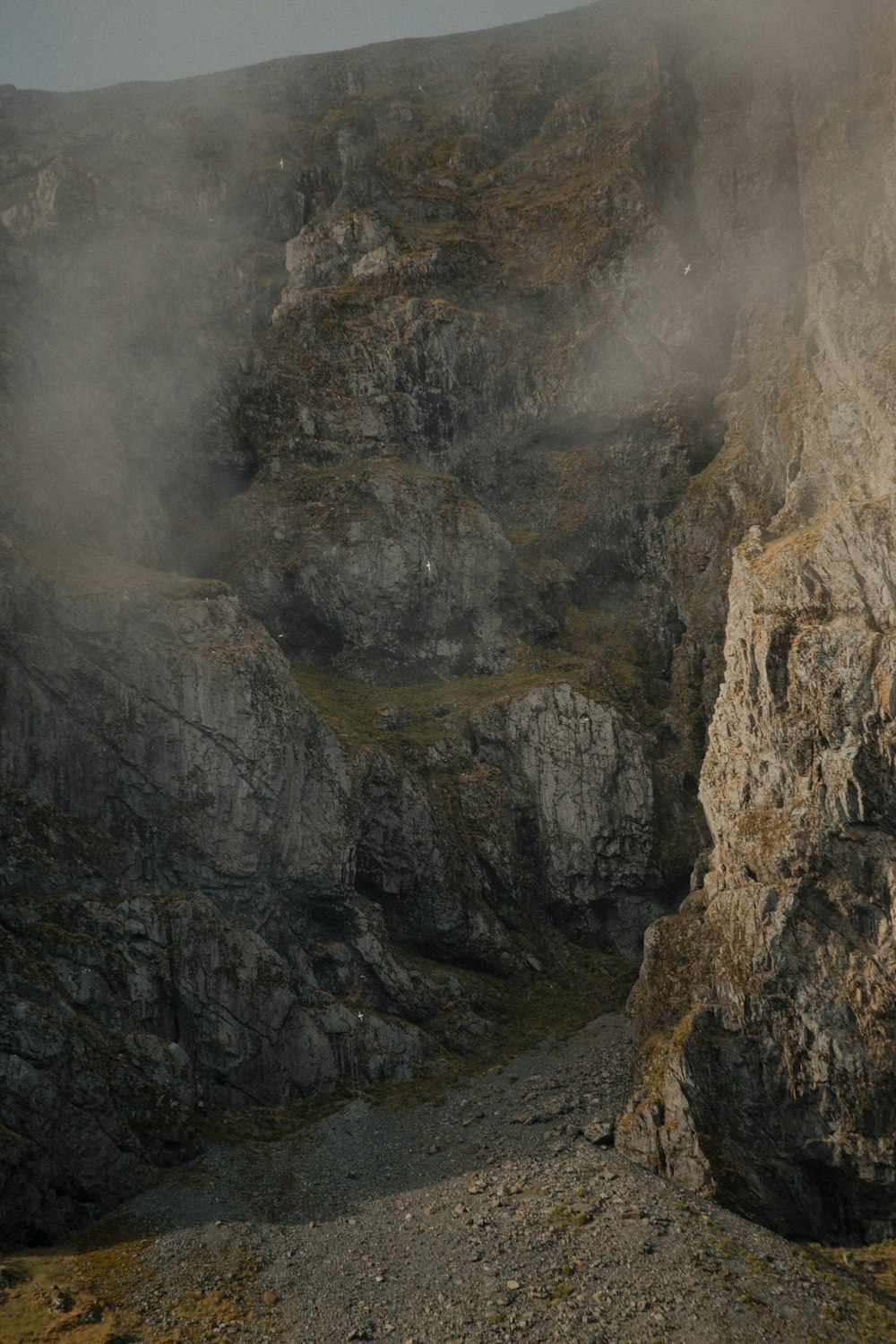 brown rocky mountain with fog