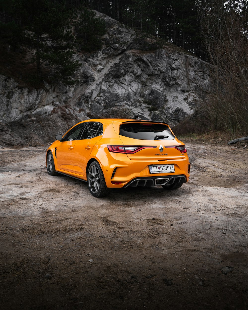 orange and black bmw m 3 coupe on dirt road