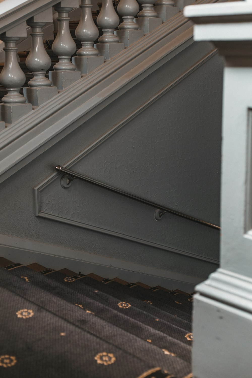 black metal fence on brown wooden staircase