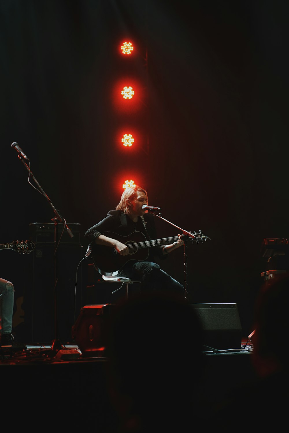 man playing guitar on stage