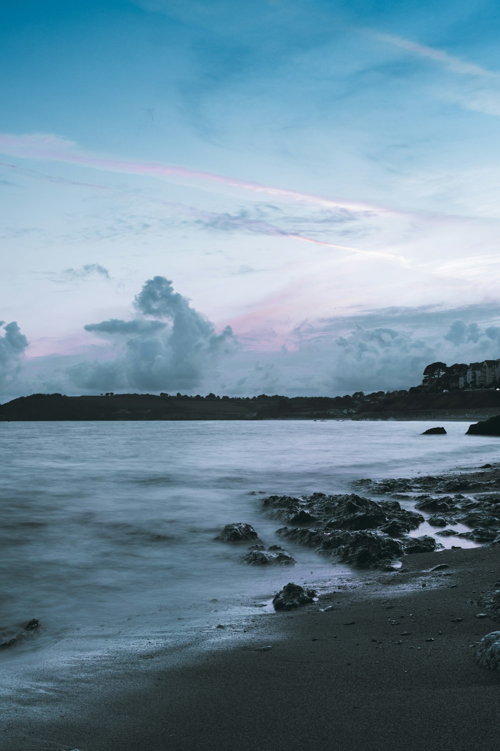 body of water under cloudy sky during daytime