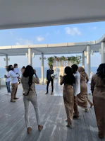 An aerial shot of a wedding ceremony set against a scenic coastline.