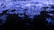 Waves of vibrant blue light ripple across a dark surface, creating a dynamic and fluid visual effect reminiscent of water or liquid textures. The intricate patterns and reflections evoke a sense of movement and energy.