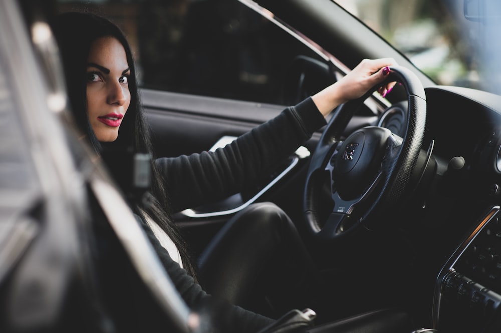 woman in black long sleeve shirt driving car