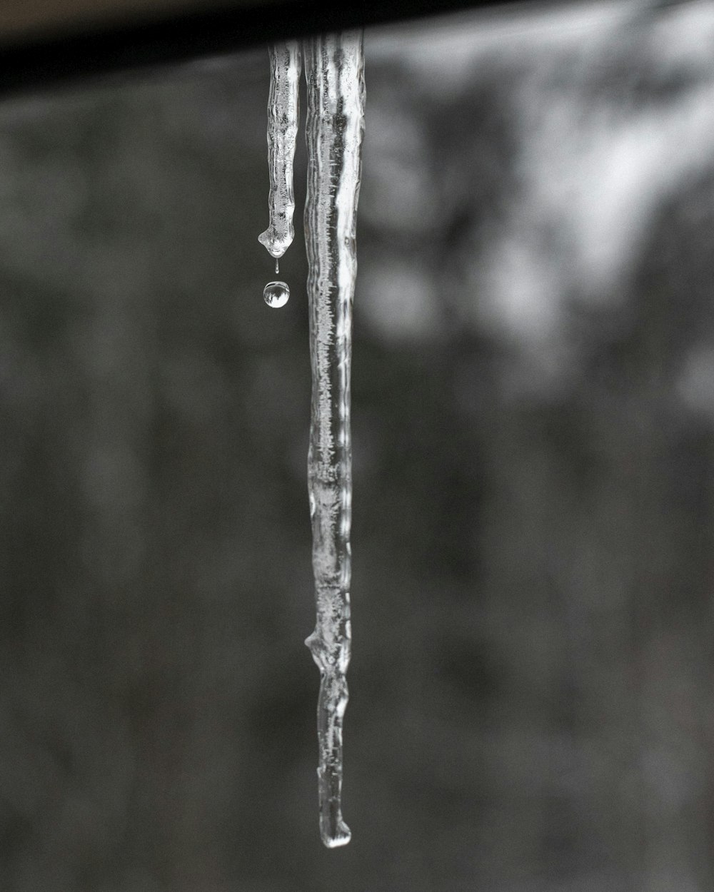 water dew on gray metal stick