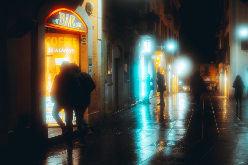 person walking on sidewalk during night time