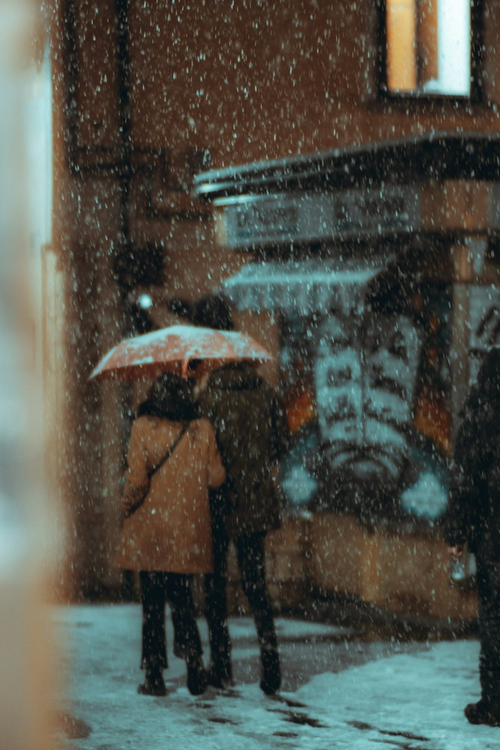 person holding umbrella during rain