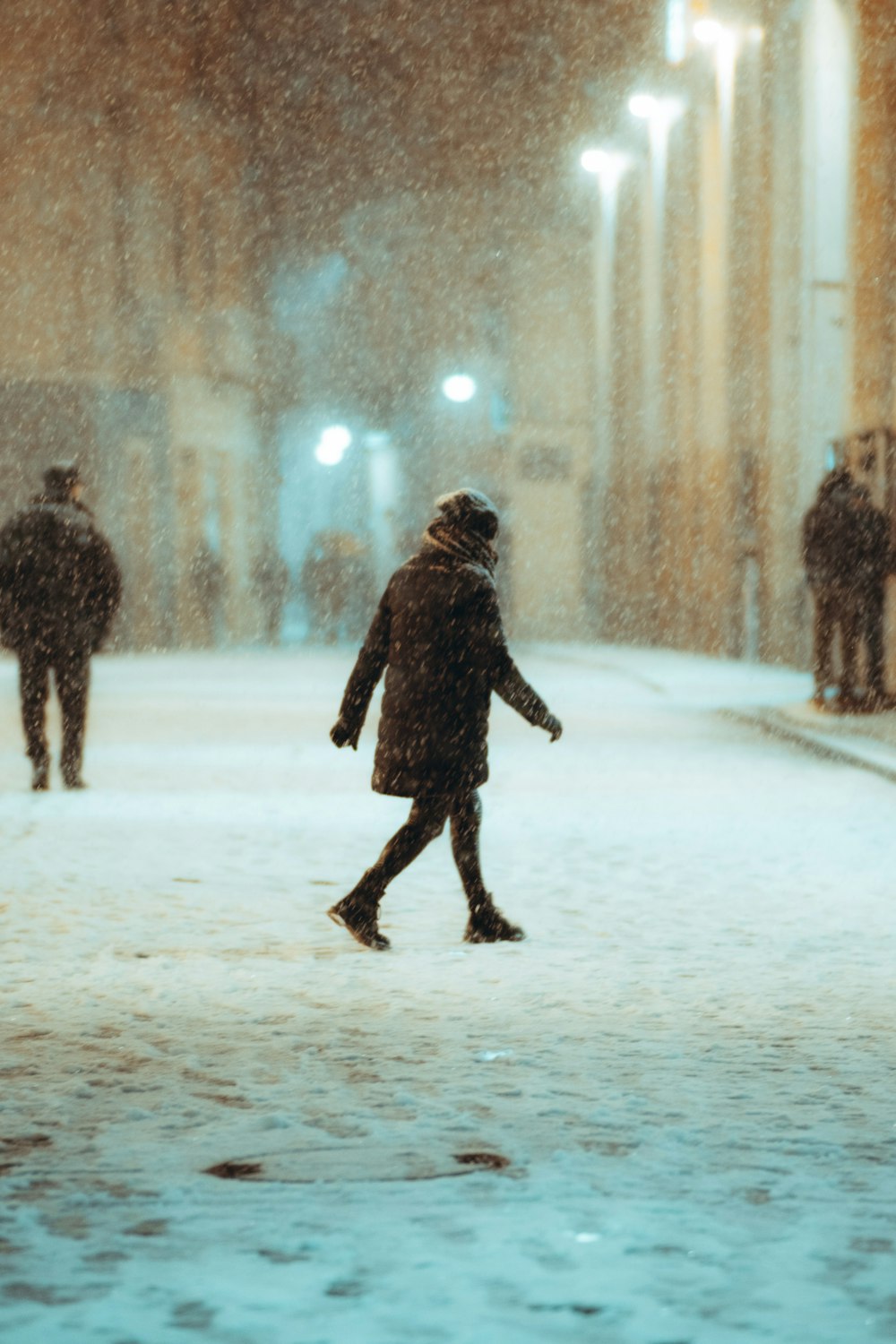 person walking on snow covered ground during daytime