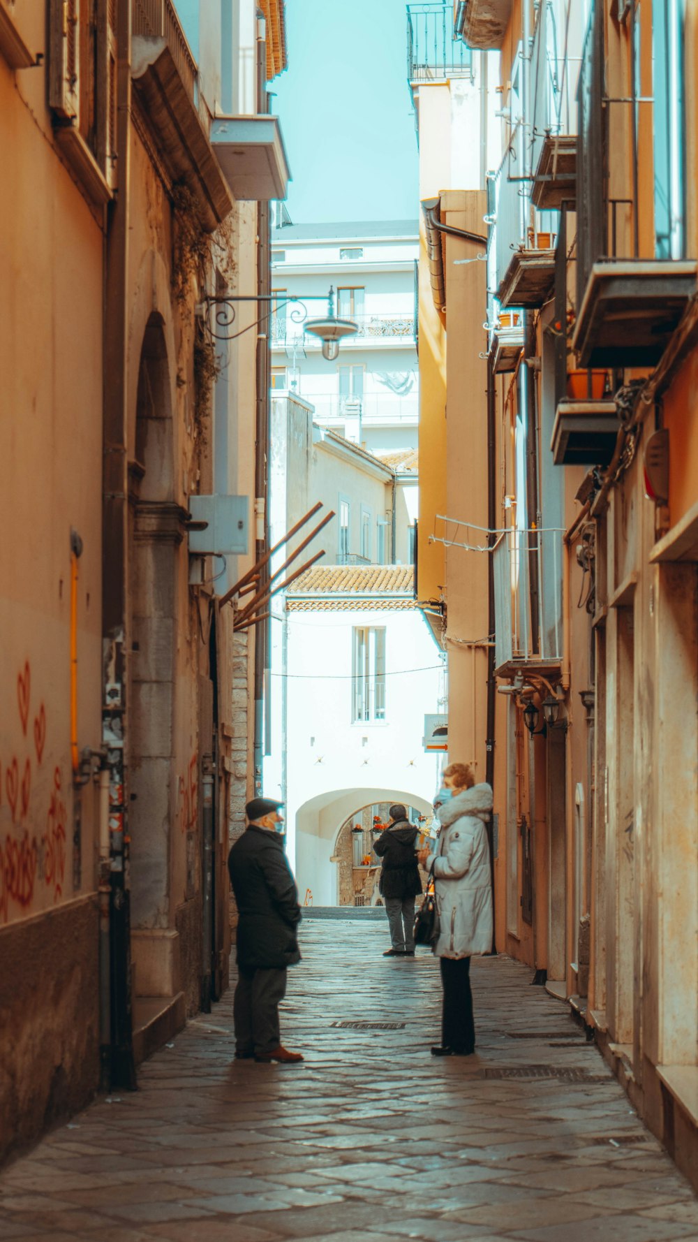 man in black jacket walking on street during daytime