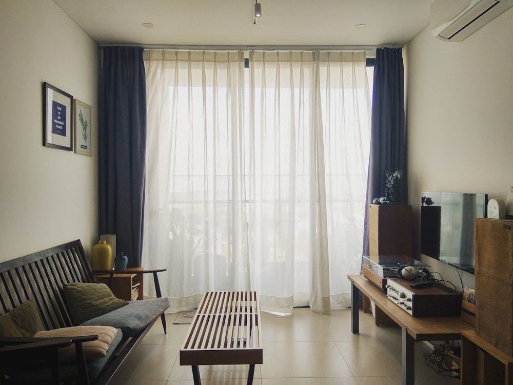 white window curtain near brown wooden table