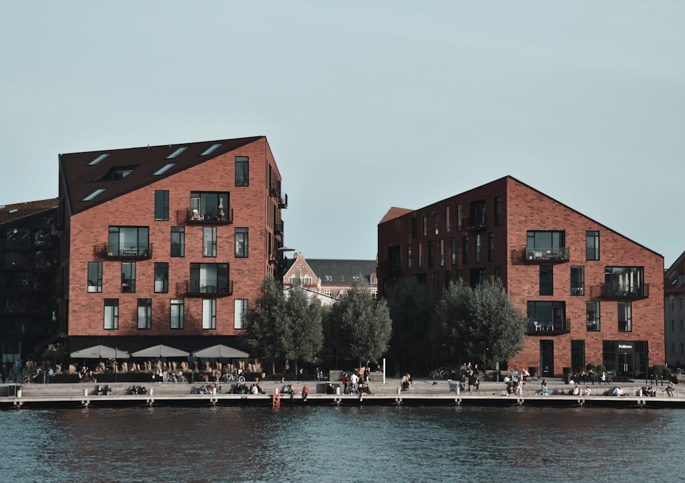 brown concrete building beside body of water during daytime