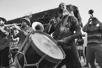 Close-up of musicians passionately playing instruments during a festive outdoor concert.