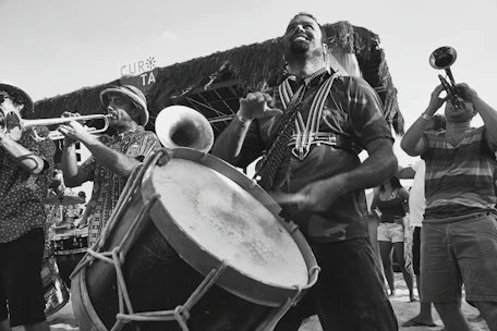 Close-up of musicians passionately playing instruments during a festive outdoor concert.