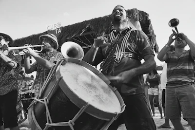 A lively scene of a Louisiana jazz festival with musicians playing and people enjoying the moment.