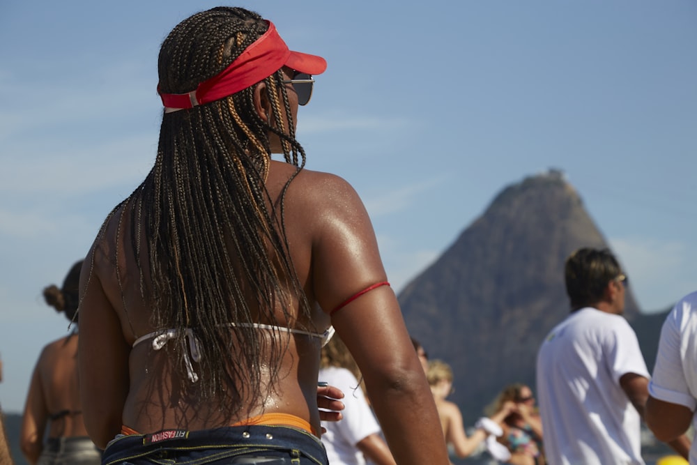 woman in red knit cap and white tank top