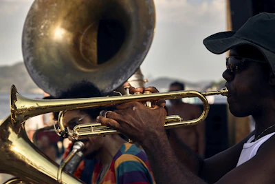 Trumpet players performing at a community park event, engaging families and children.