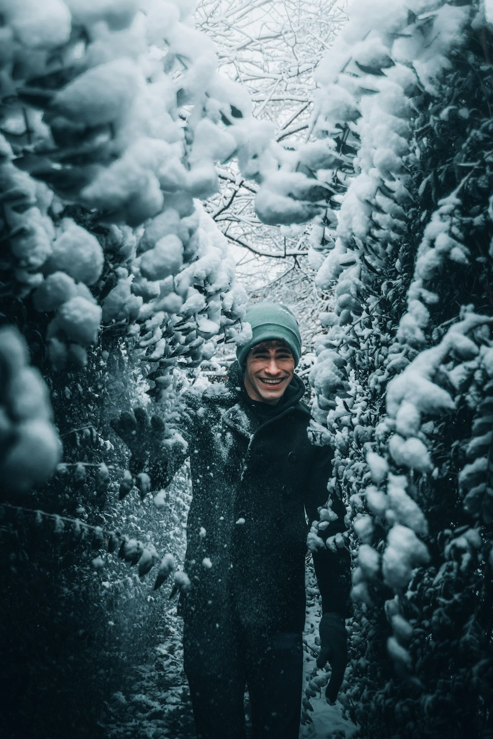 woman in black coat standing on snow covered ground