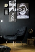 black leather armchair beside black wall