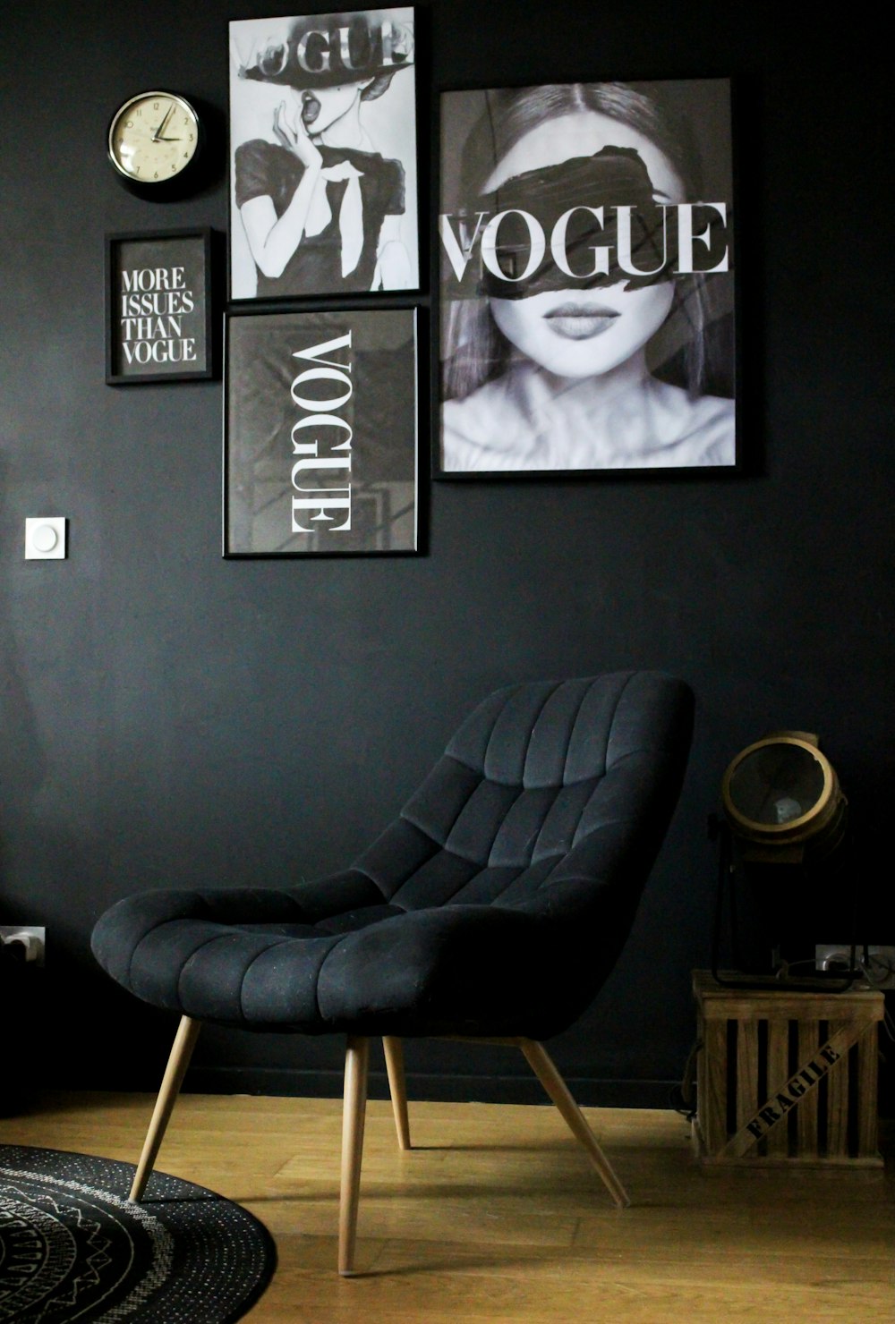 black leather armchair beside black wall