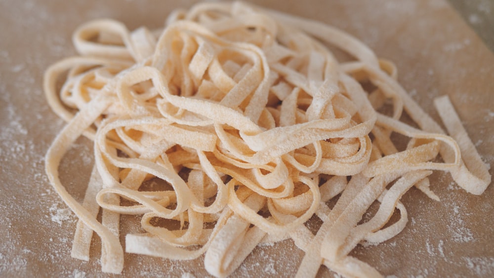 white pasta on brown wooden table