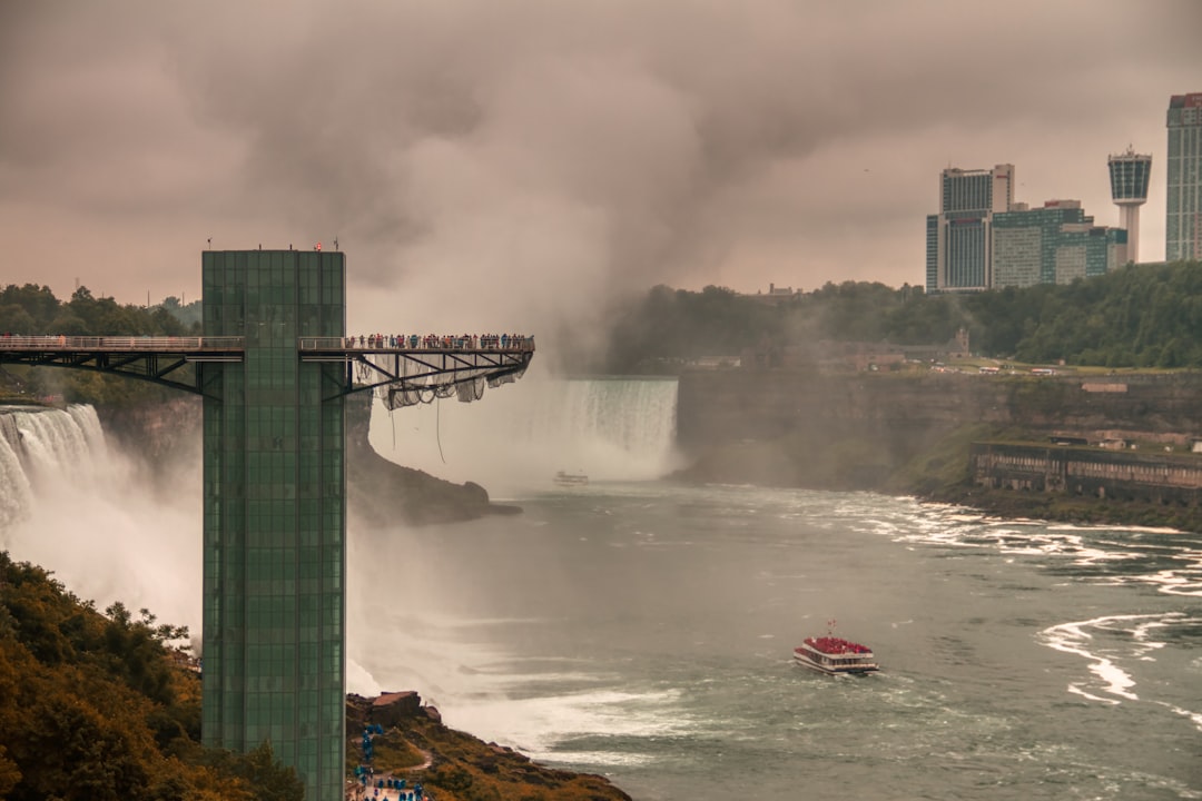 water falls near bridge during daytime