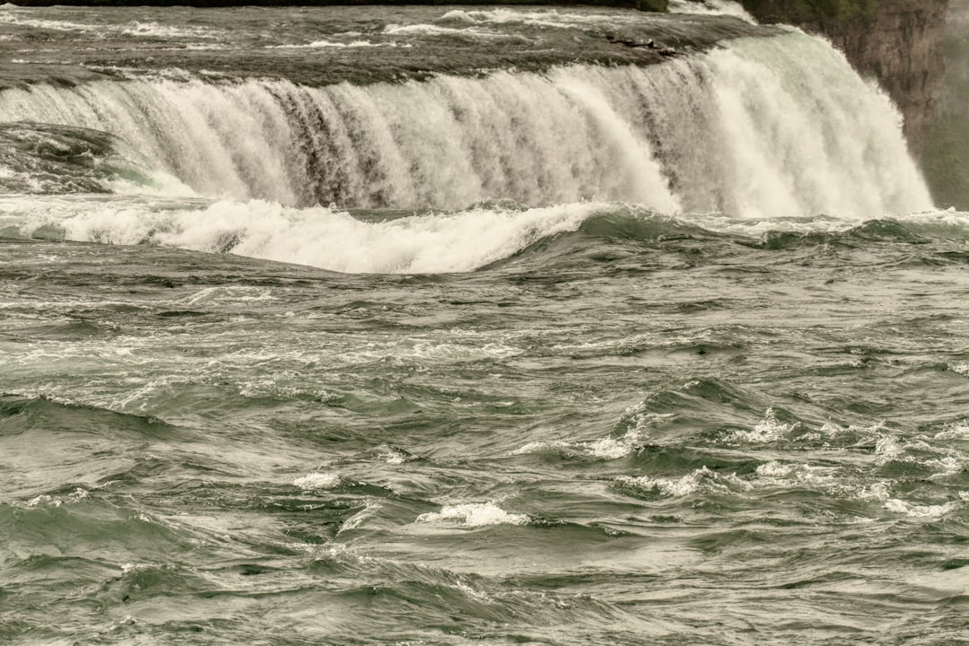 water falls on green water