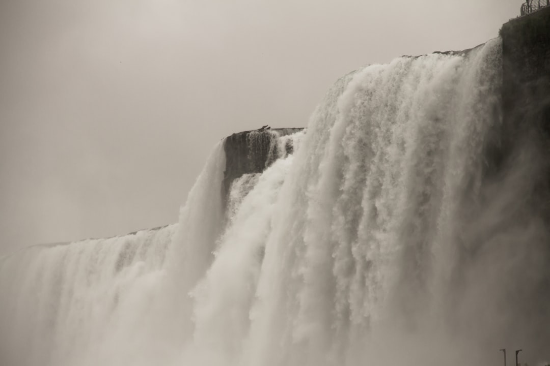 white waterfalls under gray sky