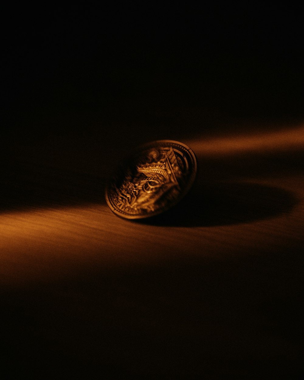 gold round coin on brown wooden table