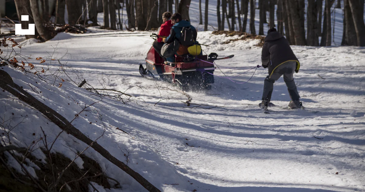 People riding ski lift on snow covered ground during daytime photo ...