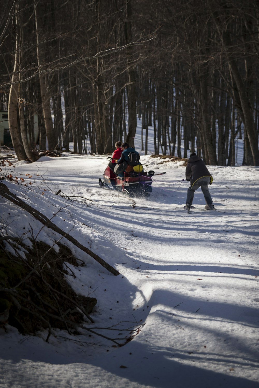 people riding ski lift on snow covered ground during daytime