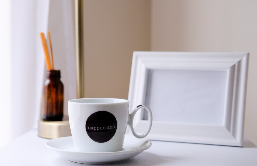 white ceramic mug on white ceramic saucer