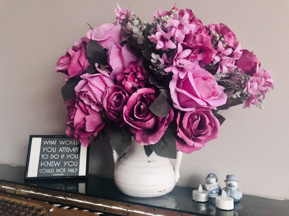 purple flower on white ceramic vase