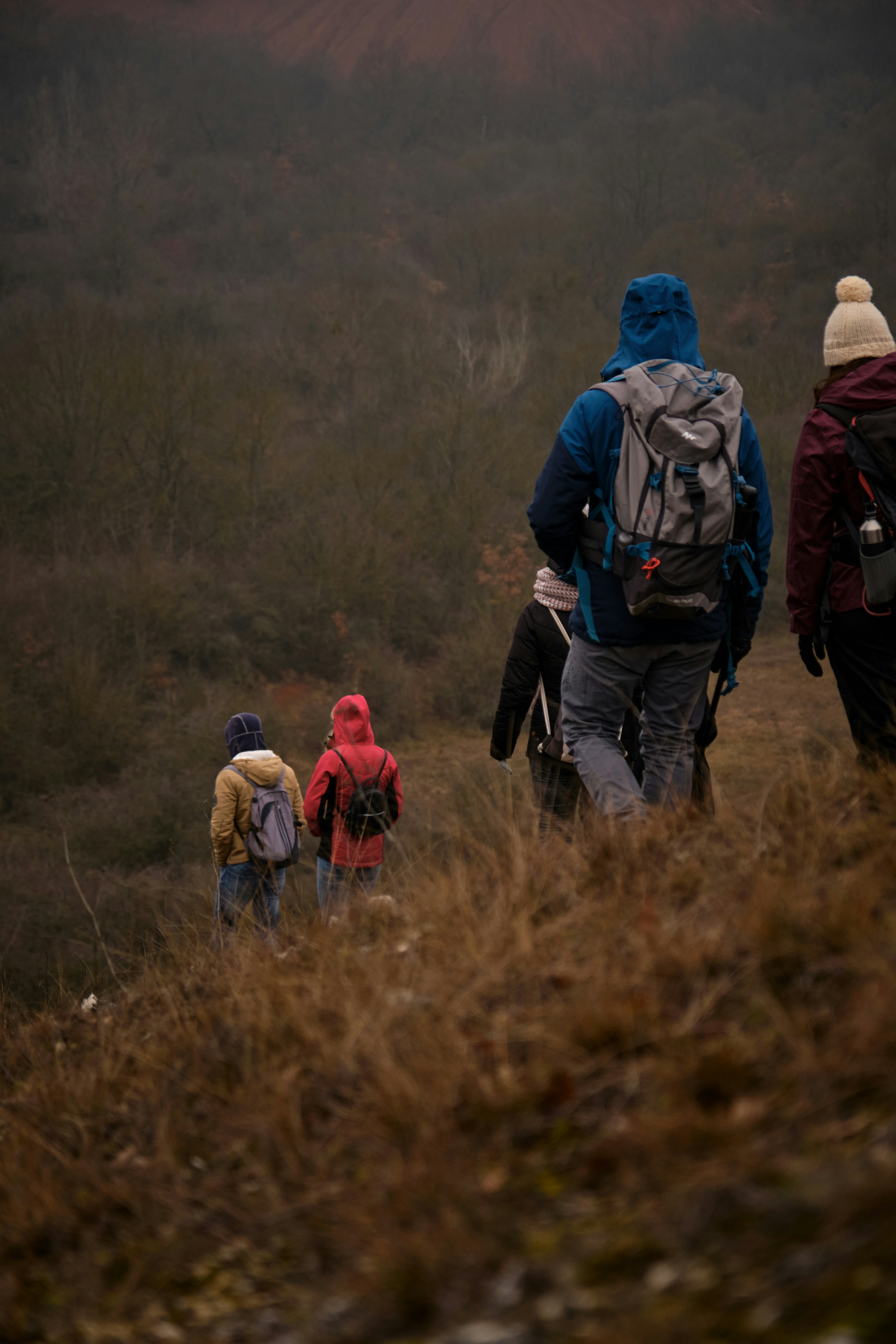 A group of people walking down a dirt road