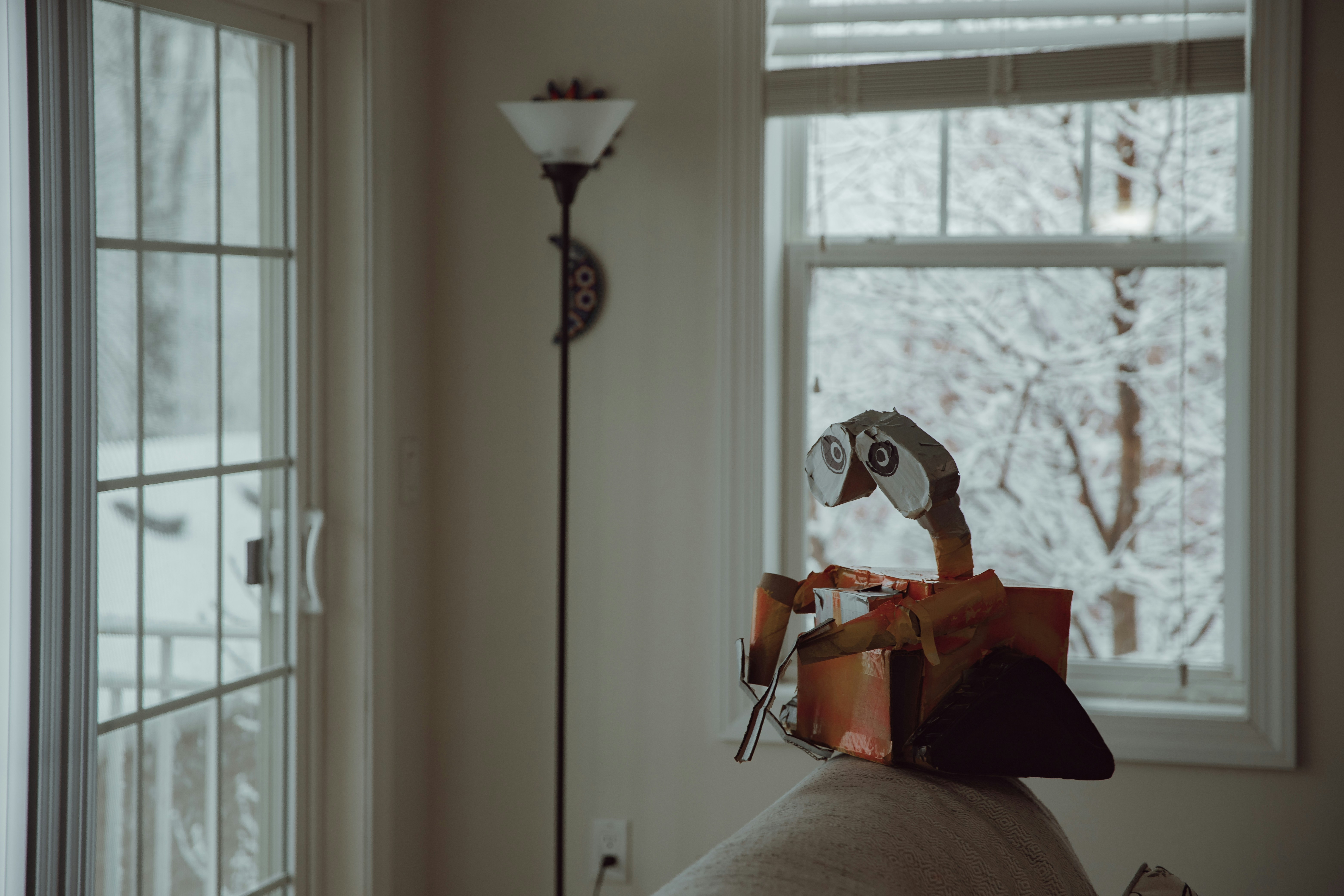white and black torchiere lamp beside white window curtain