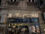 Storefront view of ‘jaiswal & sons’ elegant signage illuminated softly in the evening.