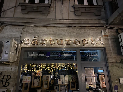 Storefront view of ‘jaiswal & sons’ elegant signage illuminated softly in the evening.