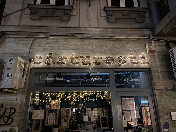 A storefront with elegant lightbox signage illuminating the business name at dusk.