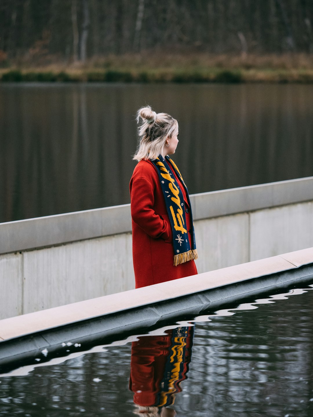 woman in red and blue jacket standing on boat during daytime