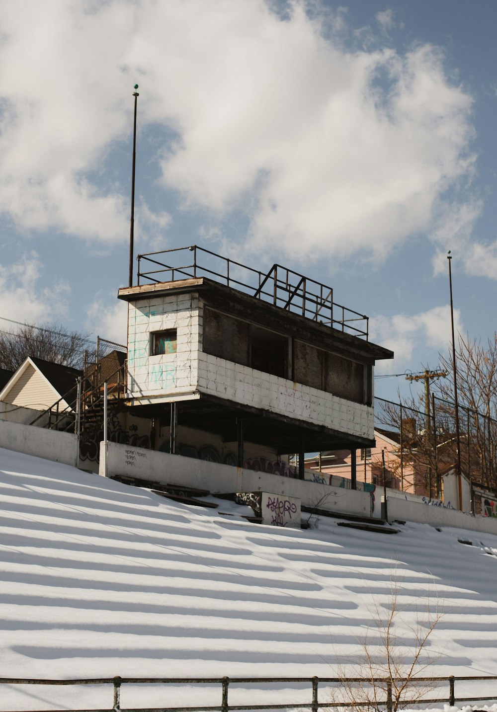 white and brown concrete building under white clouds during daytime