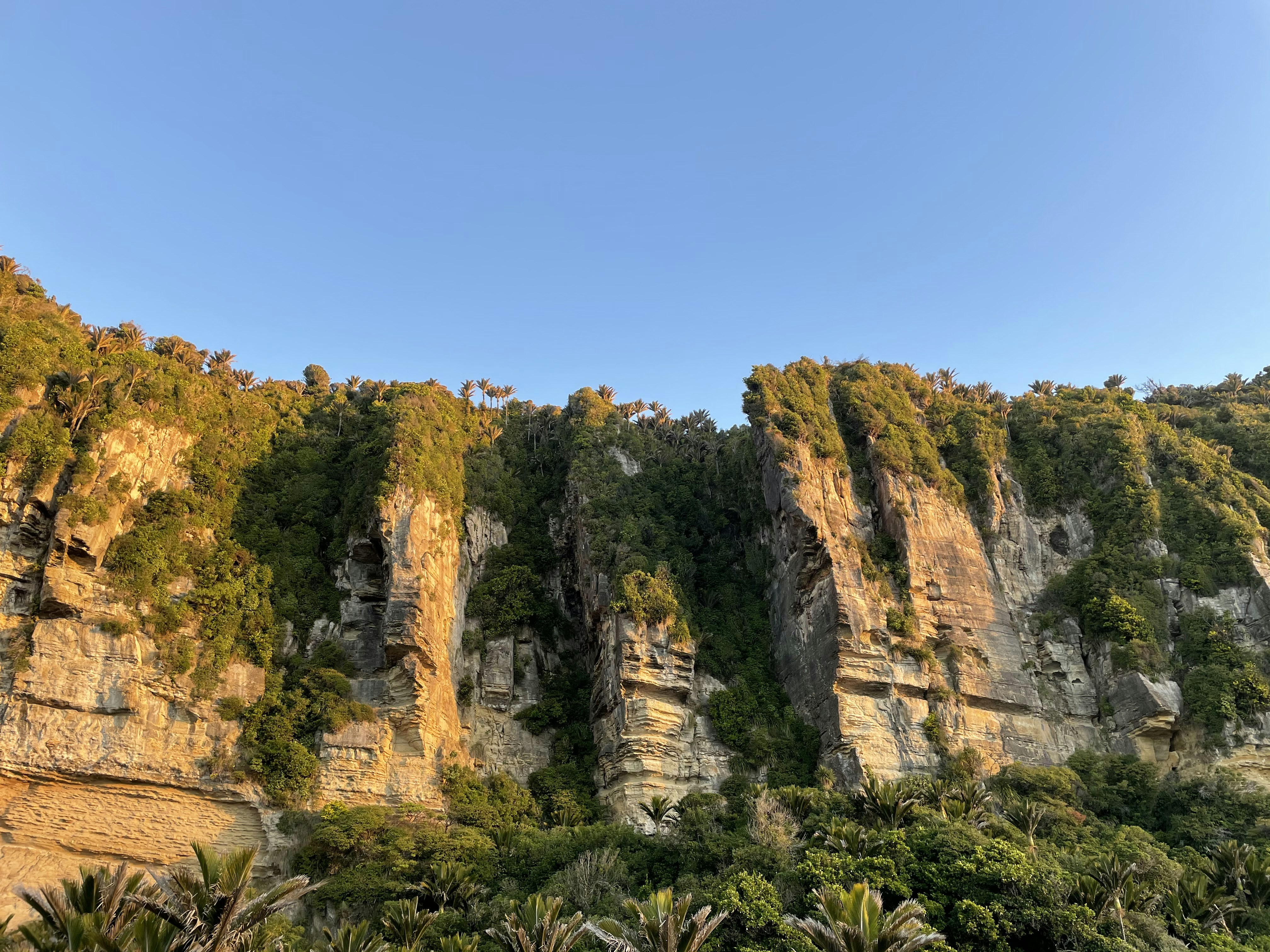 Lush Palawan landscape with limestone cliffs and emerald lagoon, tropical paradise, bright midday light, expansive sky