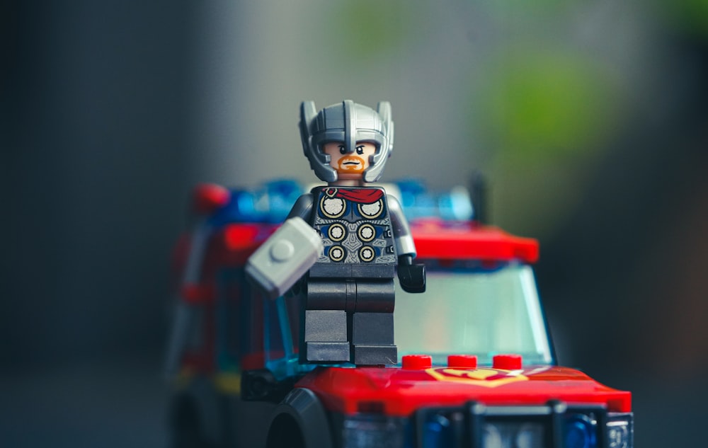 lego minifig on red and blue plastic toy